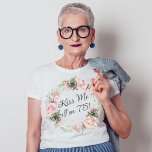 Funny Kiss Me I'm 75 Pink Roses Floral T-Shirt<br><div class="desc">Kiss the birthday lady celebrating an important milestone birthday with this custom funny t-shirt. It features a beautiful wreath of watercolor pastel pink roses and mixed flowers and greenery surrounding the text "Kiss Me I'm 75!". You can substitute any age in place of 75 or change the text to any...</div>