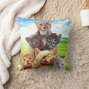 Funny kittens in green field.                      throw pillow