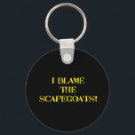 Funny Scapegoat Quote A Bold Statement on Blame Keychain<br><div class="desc">This striking image delivers a punchy message—"I BLAME THE SCAPEGOATS!"—in distressed yellow stencil text against a stark black background. It's a satirical take on the human tendency to deflect responsibility,  making it perfect for social commentary,  humor,  or protest-themed content. #BlameCulture #SatireArt #ScapegoatStatement #BoldTypography</div>