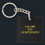 Funny Scapegoat Quote A Bold Statement on Blame Keychain<br><div class="desc">This striking image delivers a punchy message—"I BLAME THE SCAPEGOATS!"—in distressed yellow stencil text against a stark black background. It's a satirical take on the human tendency to deflect responsibility,  making it perfect for social commentary,  humor,  or protest-themed content. #BlameCulture #SatireArt #ScapegoatStatement #BoldTypography</div>