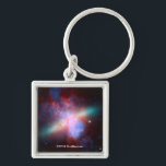 Galaxy M82 Keychain<br><div class="desc">This image shows a stunning view of a Starburst galaxy produced by space telescopes. M82 is a galaxy about 12 million light years from Earth that is undergoing a burst of star formation. X-rays from Chandra (blue) show gas being blasted away from the galaxy's disc as a bounty of stars...</div>