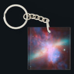 Galaxy M82 Keychain<br><div class="desc">This image shows a stunning view of a Starburst galaxy produced by space telescopes. M82 is a galaxy about 12 million light years from Earth that is undergoing a burst of star formation. X-rays from Chandra (blue) show gas being blasted away from the galaxy's disc as a bounty of stars...</div>