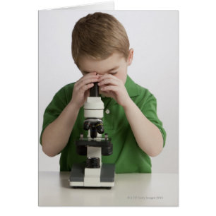 Garçon caucasien scrutant dans le microscope