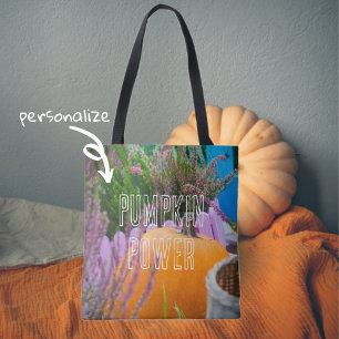 Garden still life with an orange pumpkin tote bag