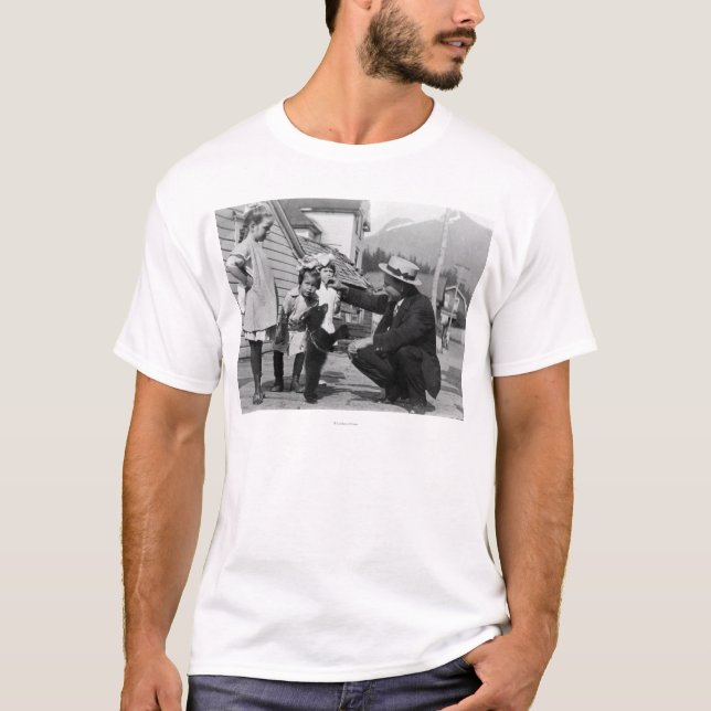 Gentleman and Kids Playing with Bear Cub On Leas T-Shirt (Front)
