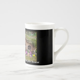 George the Mouse in a log pile house mug