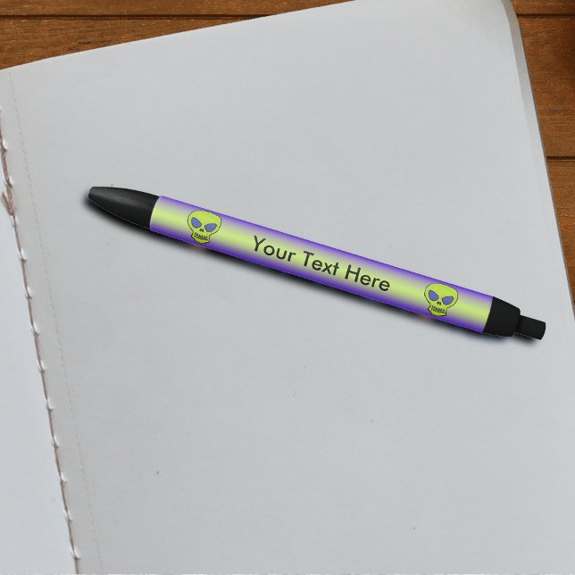 Ghoulish Green Alien Skull Black Ink Pen (Alien glowing green skulls purple eyes on purple with green stripe writing pen.)