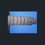 Gift Bag Canvas Print<br><div class="desc">This captivating photograph showcases the iconic Leaning Tower of Pisa standing elegantly against a deep blue twilight sky in Pisa. The historic marble tower, famous for its unmistakable tilt, is beautifully illuminated, highlighting its intricate Romanesque arches and layered columns. The soft evening light creates a striking contrast between the glowing...</div>