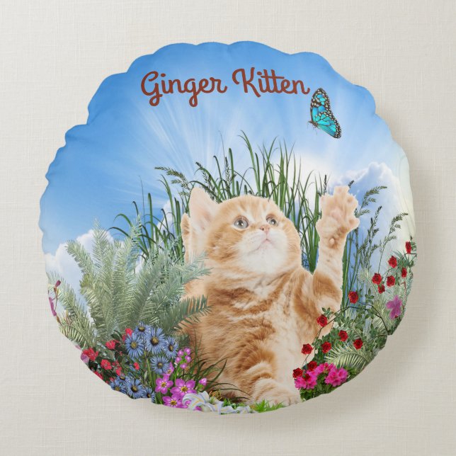 Ginger kitten playing with a butterfly round pillow (Front)