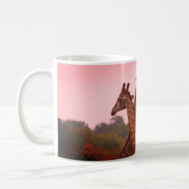 Giraffes standing in mopani trees with pink sky coffee mug (Left)