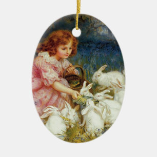 Girl feeding rabbites ceramic ornament