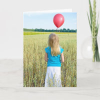 girl in wheat field with red balloon birthday