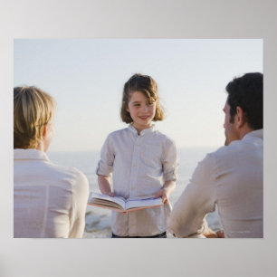 Girl reading a book in front of her parents poster