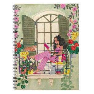 Girl reading on summer balcony with cats notebook