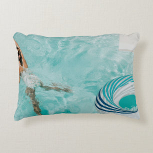 Girl wearing swimsuit and swims in swimming pool accent pillow