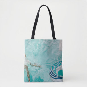 Girl wearing swimsuit and swims in swimming pool tote bag