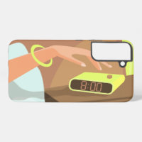 Girls hand pushing on alarm clock snooze button