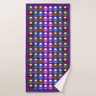 Gleaming spheres in royal purple bath towel