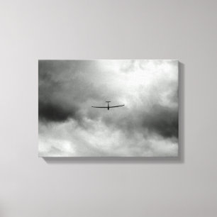 Glider flying in gray sky canvas print