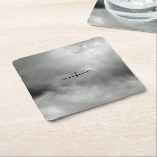 Glider flying in grey sky square paper coaster