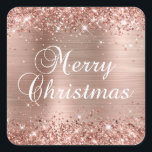 Glittery Rose Gold Foil Merry Christmas Square Sticker<br><div class="desc">Merry Christmas party favour stickers for your special holiday celebration. Girly faux sparkly rose gold glitter on the top and bottom edge over a faux blush and rose gold brushed metal style ombre foil. The colour of the Merry Christmas fancy calligraphy text graphic can be changed. The main colours in...</div>
