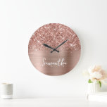 Glittery Rose Gold Glam White Script Name Large Clock<br><div class="desc">Customize the modern handwritten style script to create your own large round wall clock. Add a monogram initial behind the name to create your own first name initial combination. Girly glam faux rose gold glitter and blush pink and rose gold metallic faux foil digital art image that prints like a...</div>