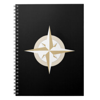 Gold and White Compass on Black Notebook