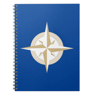 Gold and White Compass on Blue Field Notebook