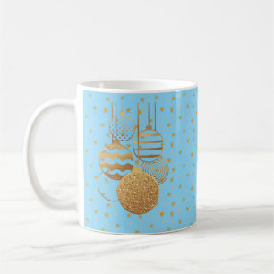 Gold baubles and stars on an ice blue background coffee mug