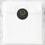Gold Black Crest Modern Monogram Wedding  Classic Round Sticker<br><div class="desc">Add a sophisticated touch to your wedding with the Gold Black Crest Modern Monogram Wedding Classic Round Sticker. Featuring a striking black background, a luxurious gold crest design, and a personalized monogram, this sticker is perfect for enhancing your wedding invitations, favours, or stationery. Its elegant contrast and modern design make...</div>