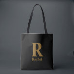 Gold/ Black Modern Minimal Monogram Name Tote Bag<br><div class="desc">Simple,  confident,  and a little bit classy without trying too hard. The oversized initial does all the talking,  while the name underneath keeps it personal. It feels like something you’d actually keep out,  because it just looks right wherever it lands.</div>