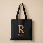 Gold/ Black Modern Minimal Monogram Name Tote Bag<br><div class="desc">Simple,  confident,  and a little bit classy without trying too hard. The oversized initial does all the talking,  while the name underneath keeps it personal. It feels like something you’d actually keep out,  because it just looks right wherever it lands.</div>