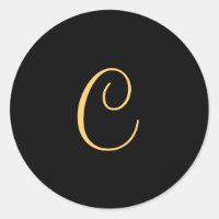 Gold-coloured initial C on black monogram  round