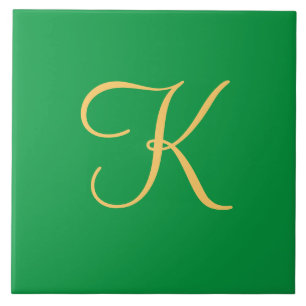 Gold-coloured initial K on solid green background Tile