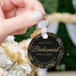 Gold Frills on Black Bridesmaid Wedding Gift Keychain<br><div class="desc">These keychains are designed to give as favours to bridesmaids in your wedding party. They feature a simple yet elegant design with a classic black background, gold script lettering, and a lacy golden faux foil floral border. The text says "Bridesmaid" with space for her name, the names of the couple,...</div>