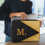 Gold Glitter Black Monogram Laptop Sleeve<br><div class="desc">Add a touch of luxury and elegance to your tech accessories with our Gold Glitter Black Monogram Laptop Sleeve. Designed for style and protection, this sleeve keeps your laptop safe while making a bold statement. Features a sleek black background adorned with a shimmering gold glitter monogram, giving it a chic...</div>