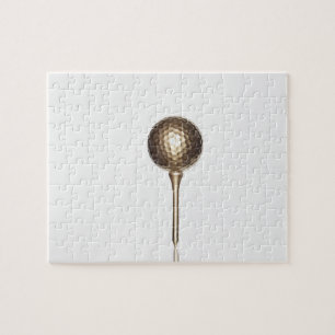 Gold golf ball and tee jigsaw puzzle