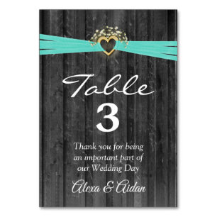 Gold Heart with Turquoise Ribbon On Grey Wood Table Number