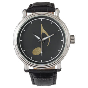 gold musical note on black watch