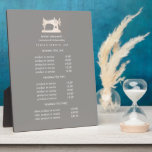Gold Sewing Machine Seamstress Grey pricing   Plaque<br><div class="desc">Understated design displays your services, price list or business information beneath an illustration of a vintage sewing machin in faux gold over a Grey taupe background and your name or business name. Includes three customizable headings and body text fields. To adjust layout, enter your text and then use the Customize...</div>