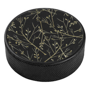 Gold Twigs on Black Hockey Puck