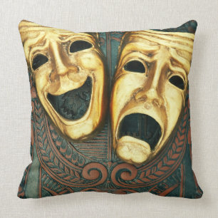 Golden comedy and tragedy masks on patterned throw pillow