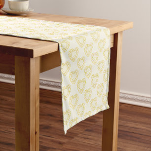 Golden diamond gem hearts on pale yellow short table runner