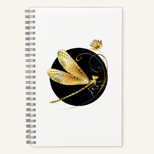 Golden dragonfly in black circle notebook