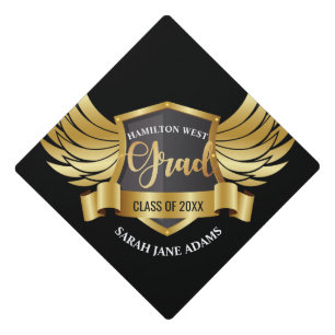 Golden eagle wings shield crest with ribbon text graduation cap topper