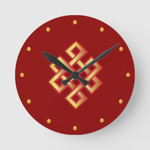 Golden endless knot on maroon round clock