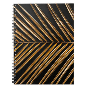 Golden painted date palm leaf closeup on abstract  notebook