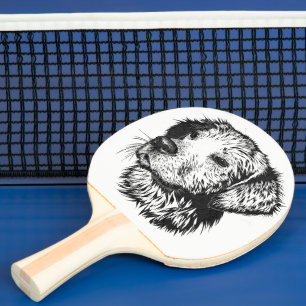 Golden retriever puppy portrait in black and white ping pong paddle