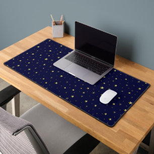 Golden shiny stars on blue background desk mat