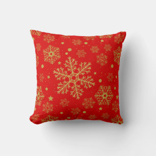 Golden snowflakes on red throw pillow
